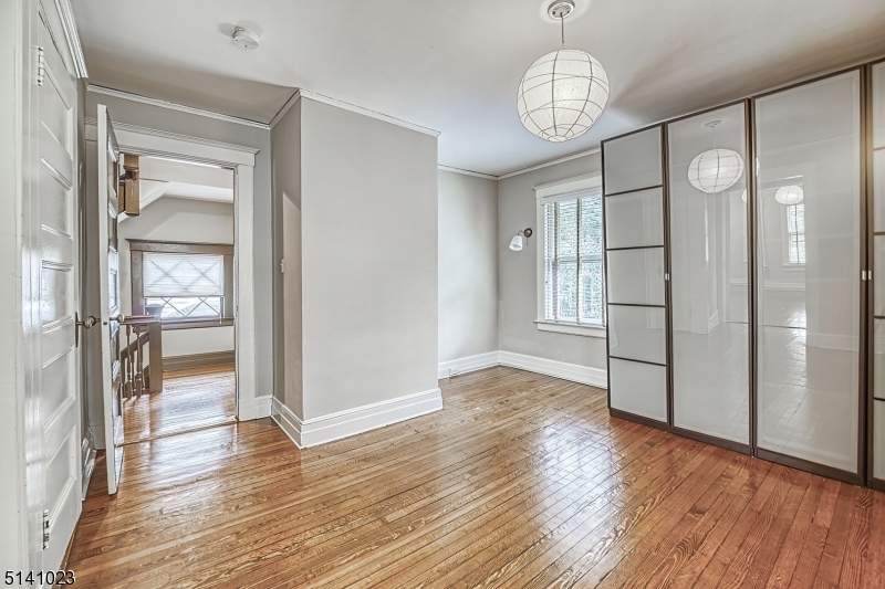 42 Gates Avenue Montclair, NJ 07042 - Photo 24 of 44 a view of a hallway with wooden floor and a chandelier