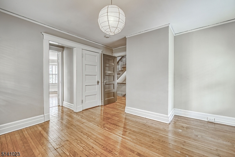 42 Gates Avenue Montclair, NJ 07042 - Photo 25 of 44 an empty room with wooden floor cabinet and windows