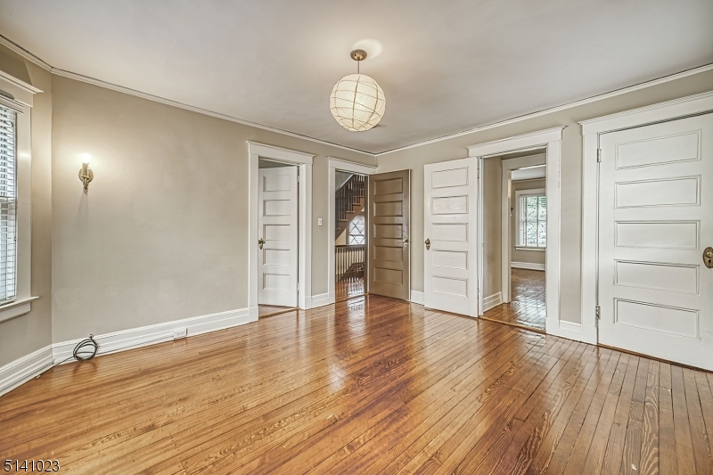 42 Gates Avenue Montclair, NJ 07042 - Photo 29 of 44 an empty room with wooden floor cabinet and windows
