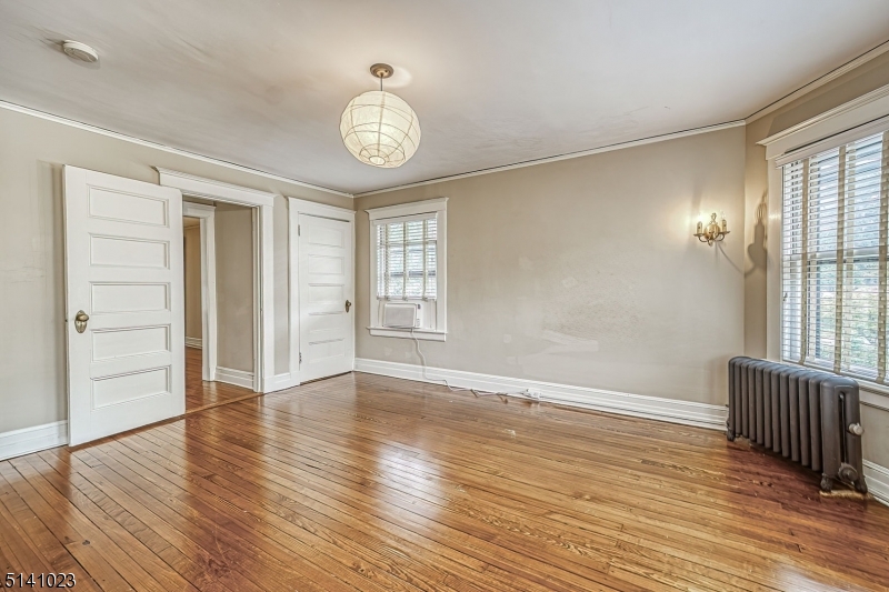 42 Gates Avenue Montclair, NJ 07042 - Photo 30 of 44 an empty room with wooden floor and windows