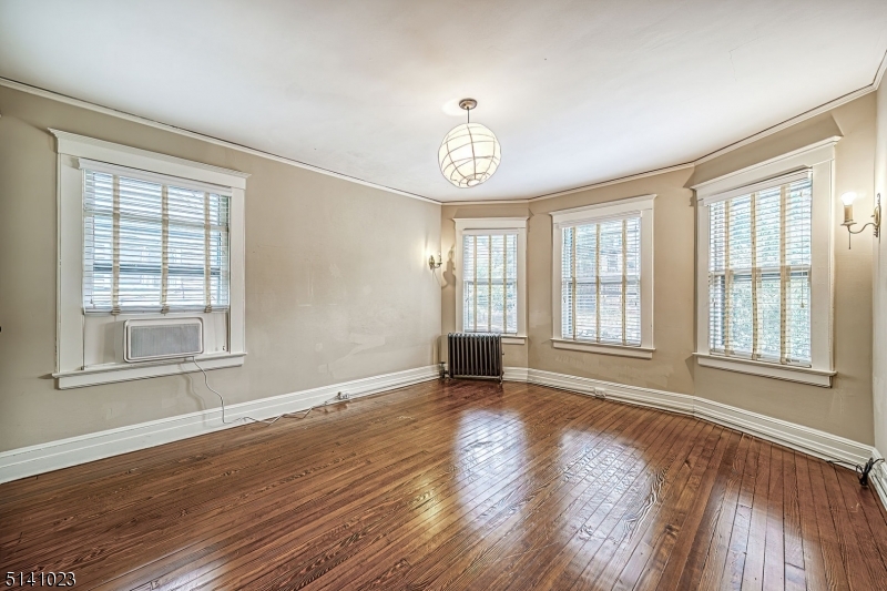 42 Gates Avenue Montclair, NJ 07042 - Photo 31 of 44 a view of an empty room with wooden floor and a window