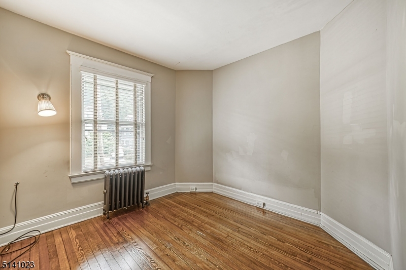 42 Gates Avenue Montclair, NJ 07042 - Photo 32 of 44 an empty room with wooden floor and windows