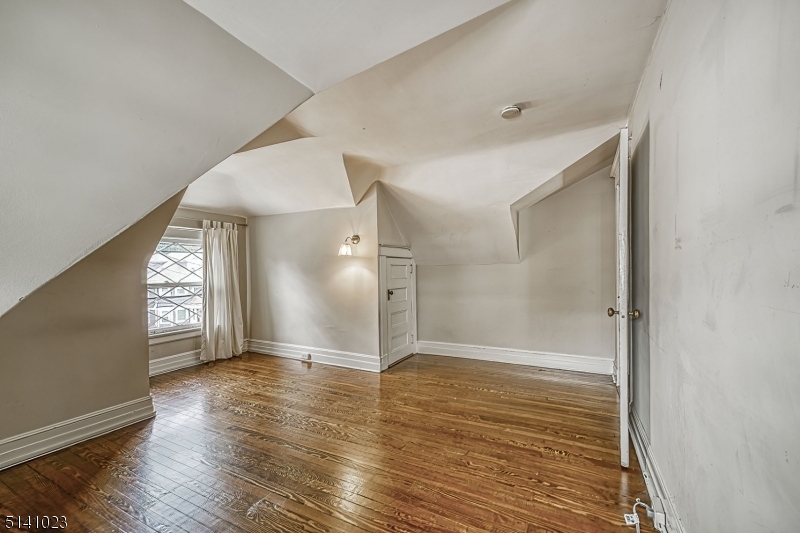 42 Gates Avenue Montclair, NJ 07042 - Photo 35 of 44 a view of an empty room with wooden floor and a window