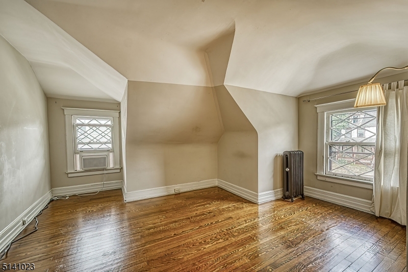 42 Gates Avenue Montclair, NJ 07042 - Photo 37 of 44 an empty room with wooden floor and windows