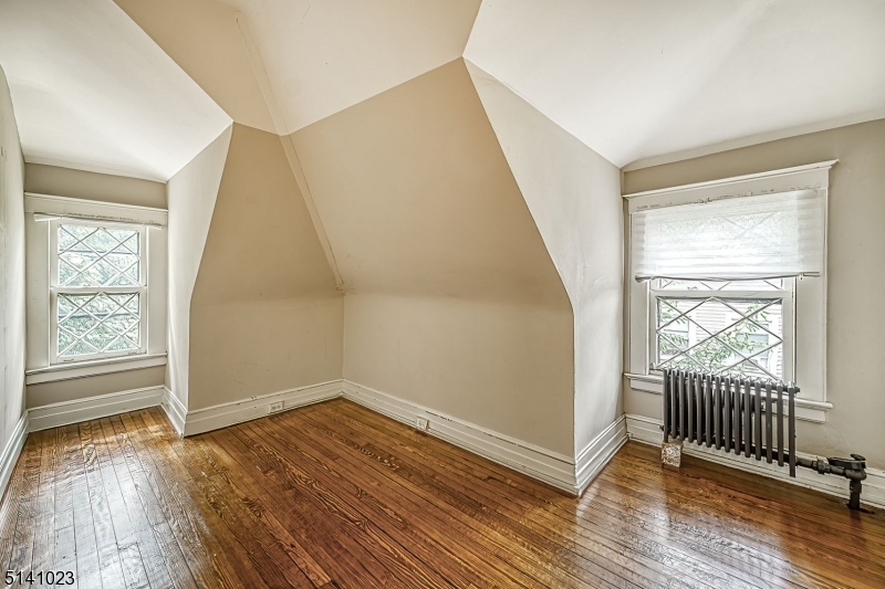 42 Gates Avenue Montclair, NJ 07042 - Photo 38 of 44 an empty room with wooden floor and windows