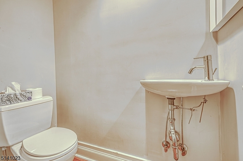 42 Gates Avenue Montclair, NJ 07042 - Photo 40 of 44 a bathroom with a sink a toilet and a mirror