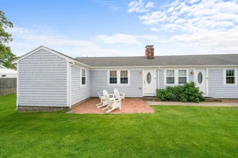 a front view of house with yard and seating area