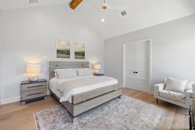 a bedroom with a bed and a night stand