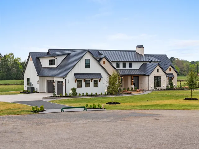 a front view of a house with a big yard