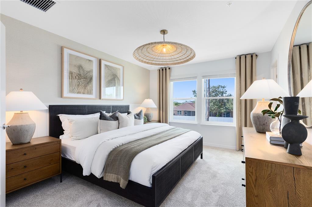4337 Jetty Lane Northeast Palm Bay, FL 32905 - Photo 20 of 31 a spacious bedroom with a bed and a chandelier