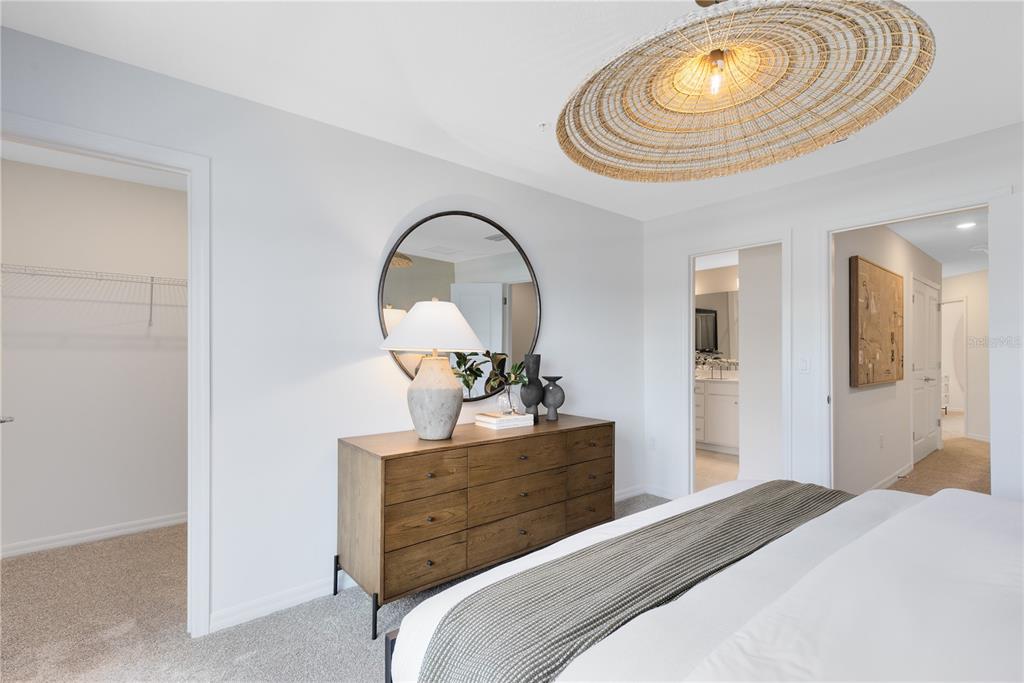 4337 Jetty Lane Northeast Palm Bay, FL 32905 - Photo 21 of 31 a bedroom with a bed and a chandelier