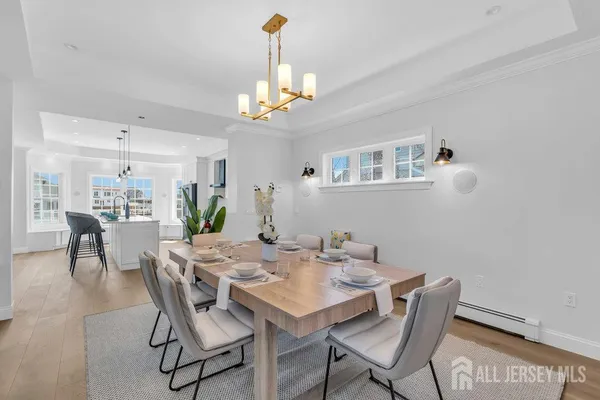 a kitchen with stainless steel appliances granite countertop a stove a sink dishwasher a microwave oven a refrigerator with white cabinets and wooden floor