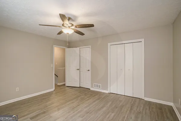 a view of an empty room and wooden floor