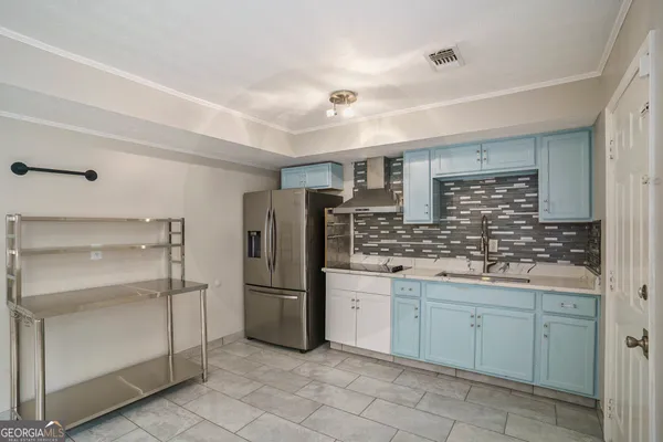 a kitchen with a refrigerator and a sink
