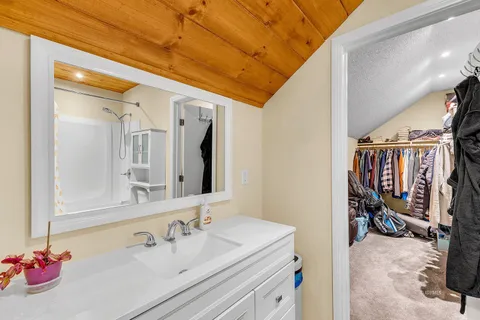 a spacious bedroom with a bed and a desk