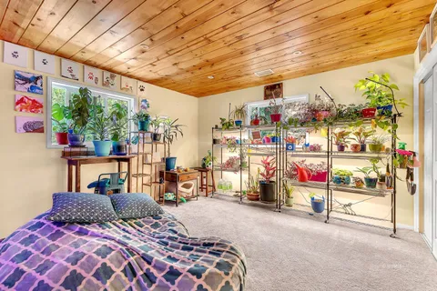 a bedroom with a bed and a tv