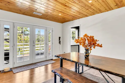 a living room with furniture a flat screen tv and kitchen view