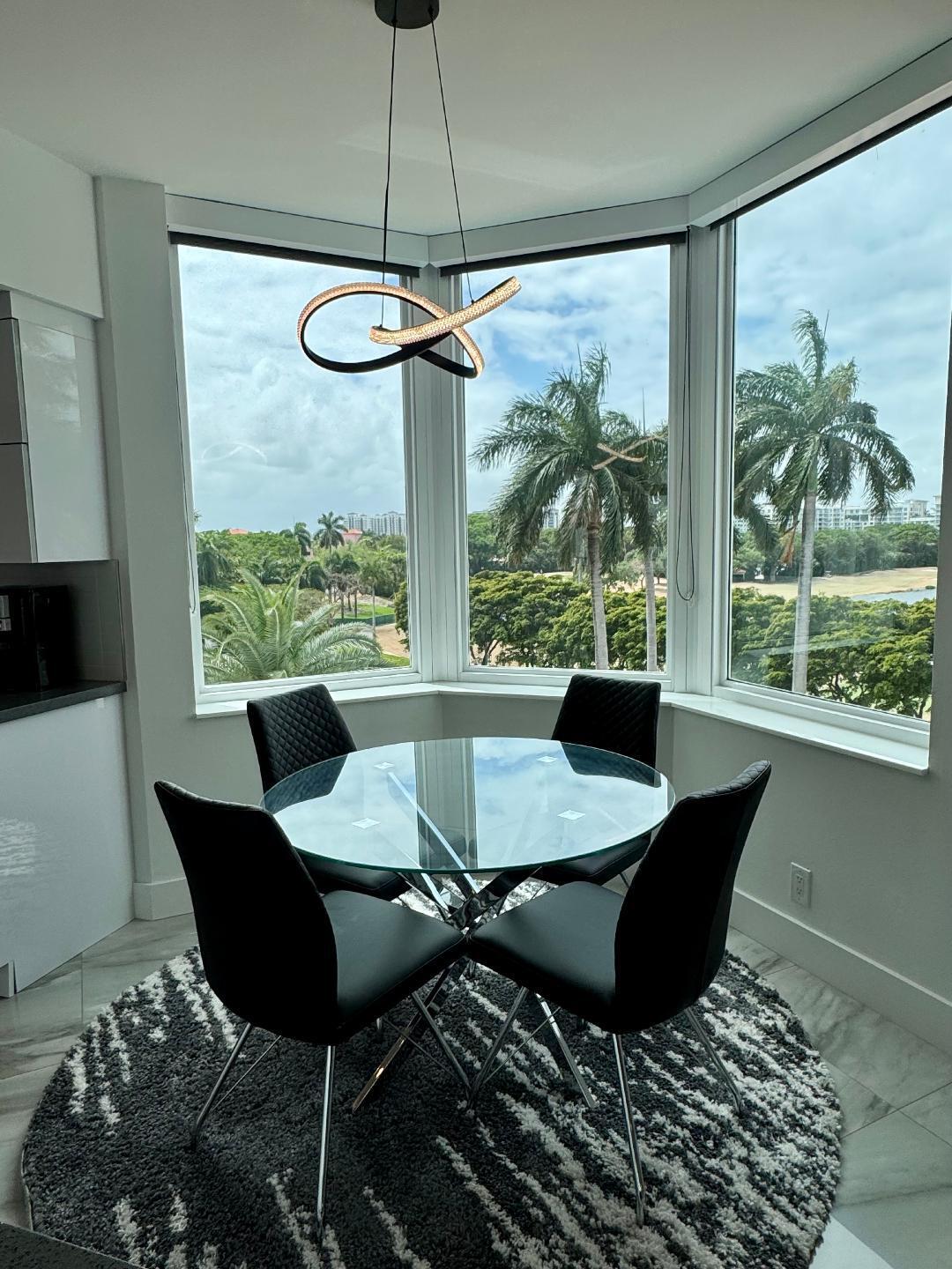 300 Southeast 5th Avenue, Unit 5180 Boca Raton, FL 33432 - Photo 14 of 45 a view of a dining room with a table and chairs
