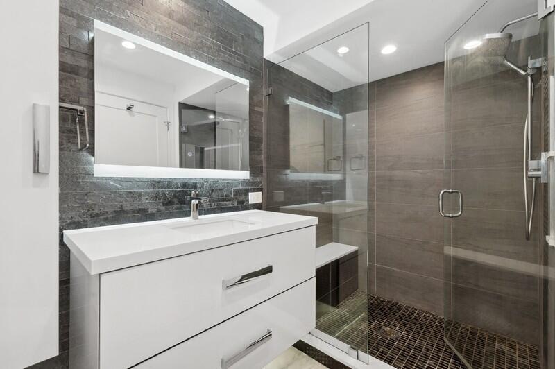 300 Southeast 5th Avenue, Unit 5180 Boca Raton, FL 33432 - Photo 24 of 45 a bathroom with a sink a toilet and shower