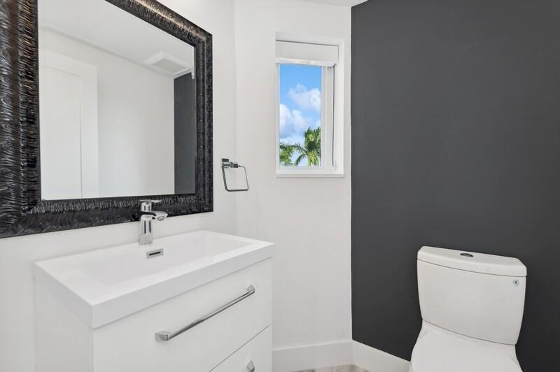 300 Southeast 5th Avenue, Unit 5180 Boca Raton, FL 33432 - Photo 30 of 45 a bathroom with a toilet sink and mirror