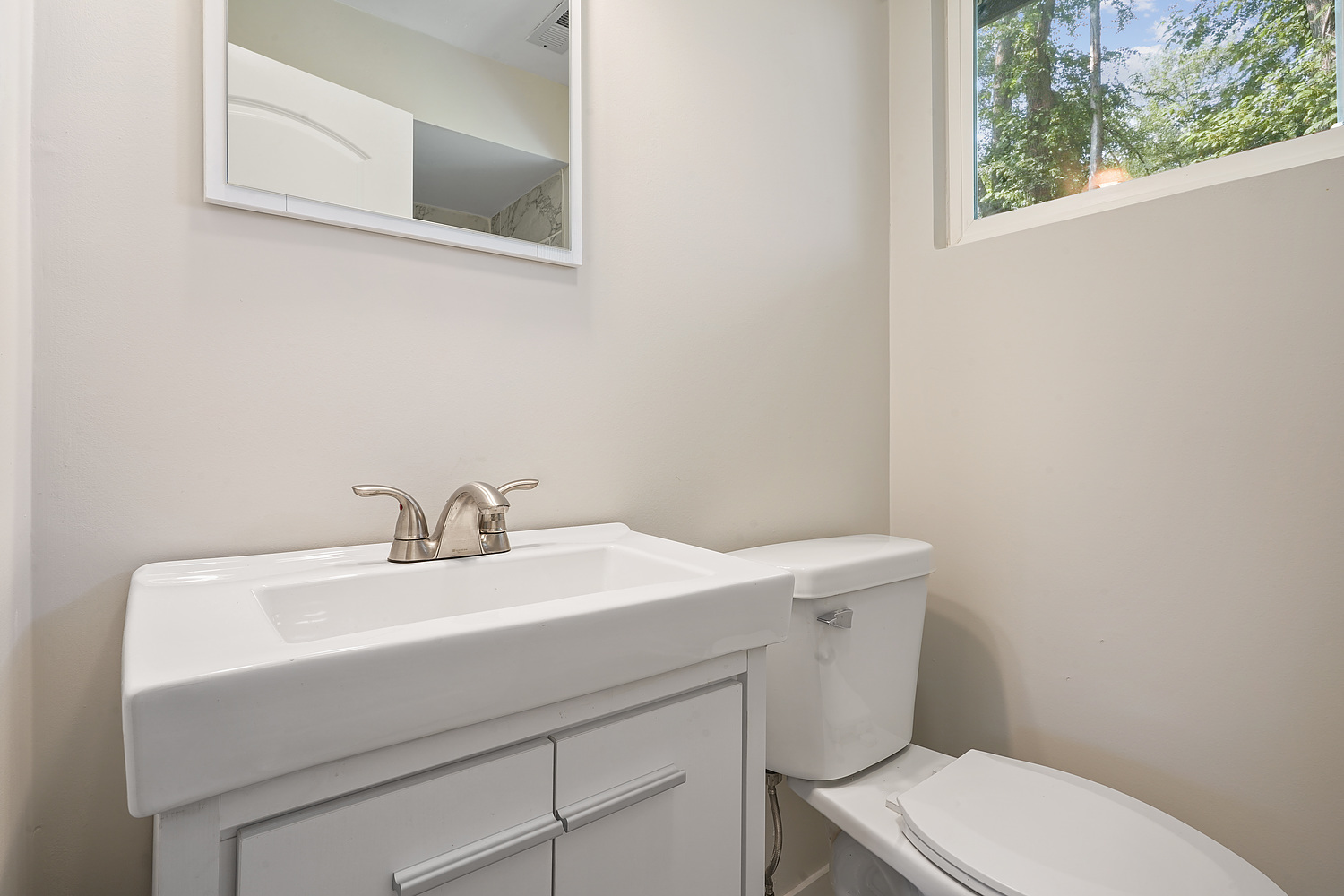 Undisclosed Address Park Forest, IL 60466 - Photo 14 of 16 a bathroom with a sink a toilet and a mirror