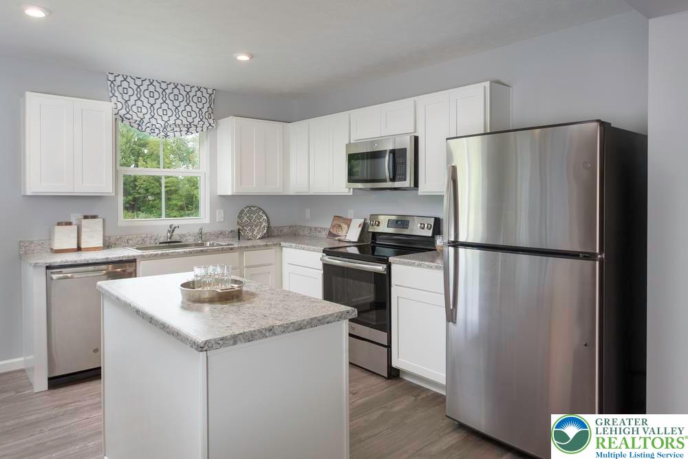 107 Shiloh Road, Unit J3 Orwigsburg, PA 17961 - Photo 7 of 13 a kitchen with a refrigerator a sink cabinets and wooden floor