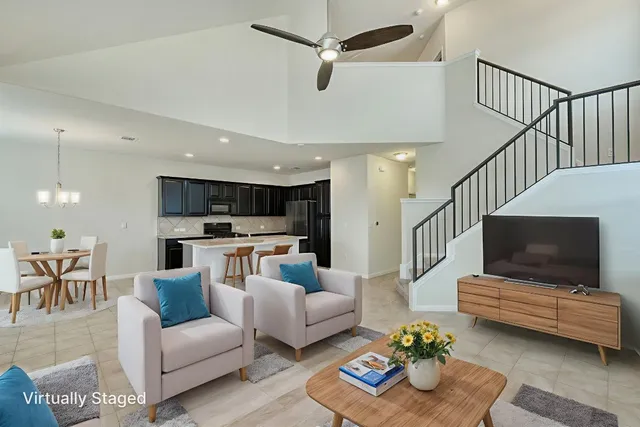 a living room with furniture kitchen view and a flat screen tv
