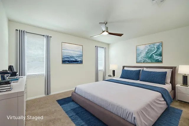 a bedroom with a large bed and a chandelier