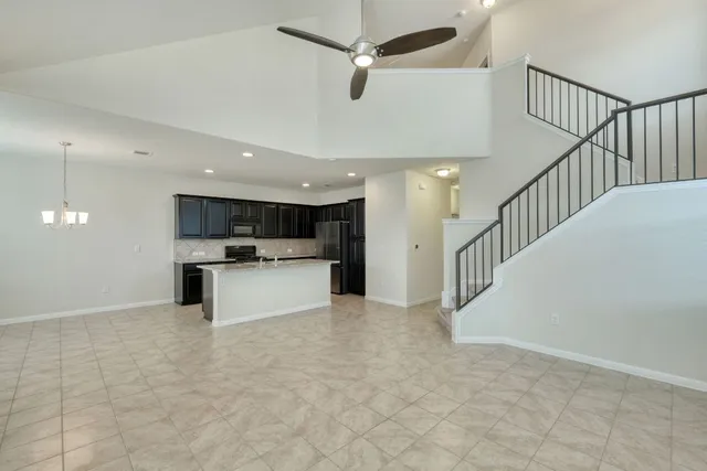 a view of kitchen with microwave and cabinets