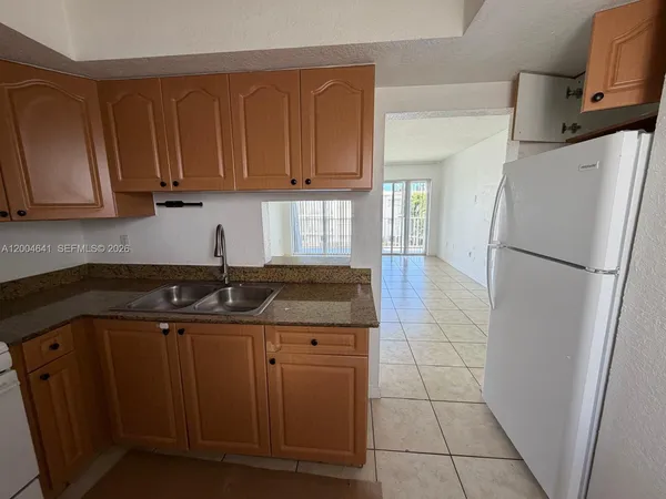 a kitchen with a sink and a refrigerator
