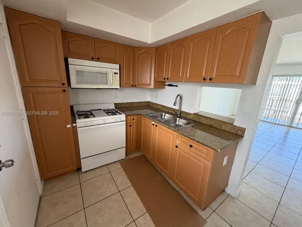 a kitchen with a sink stove and cabinets
