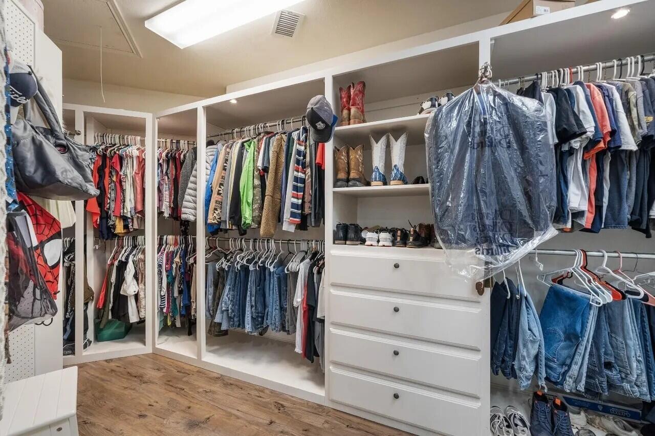 7201 87th Street Lubbock, TX 79424 - Photo 19 of 43 a view of walk in closet with clothes and shoes
