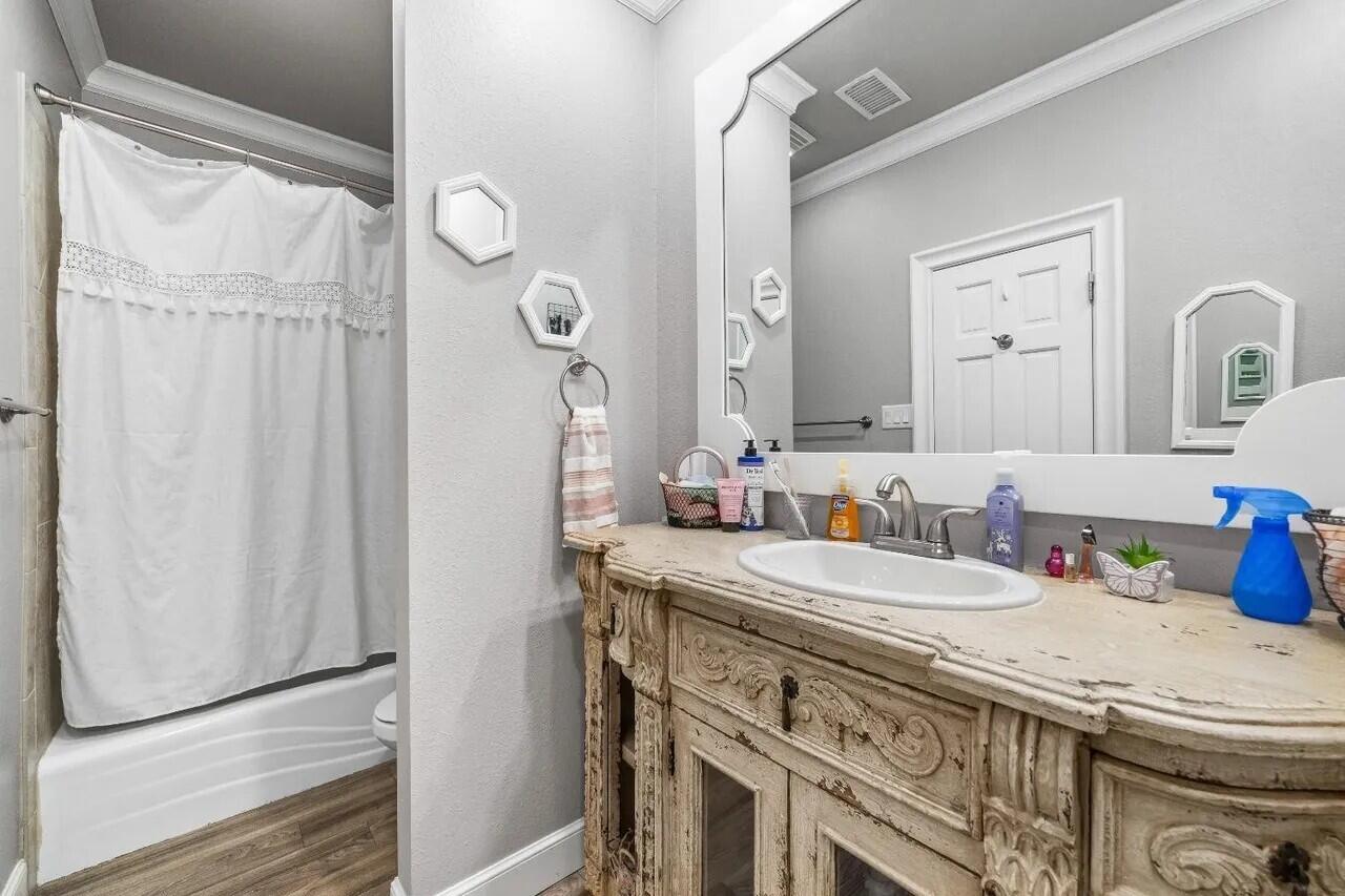 7201 87th Street Lubbock, TX 79424 - Photo 20 of 43 a bathroom with a sink vanity and a mirror
