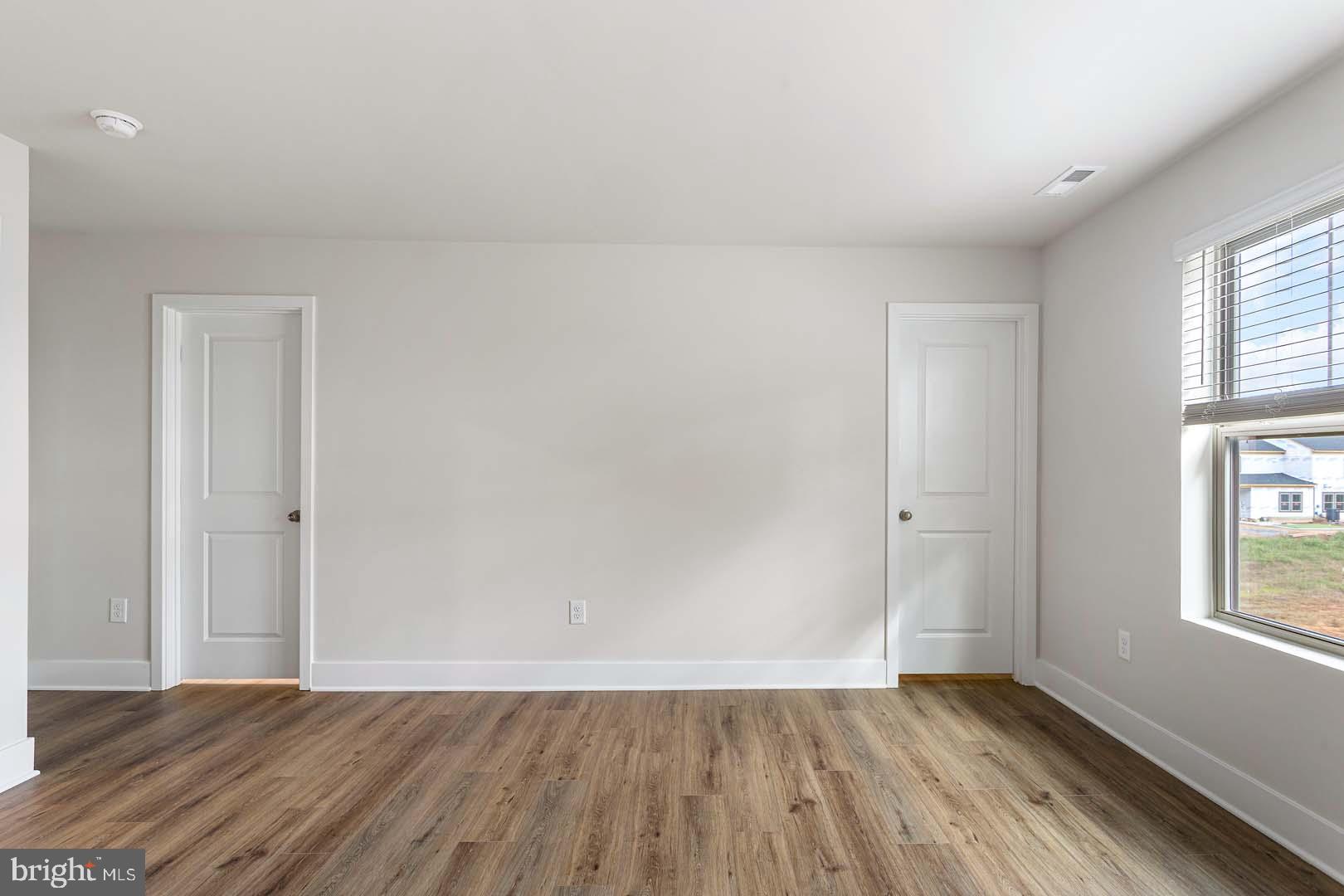 231 Matilda Frederick, MD 21701 - Photo 18 of 26 a view of an empty room with wooden floor and a window