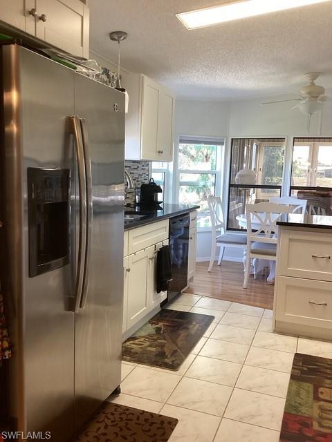 225 Belle Isle Circle Naples, FL 34112 - Photo 11 of 48 a kitchen with stainless steel appliances granite countertop a sink stove and refrigerator