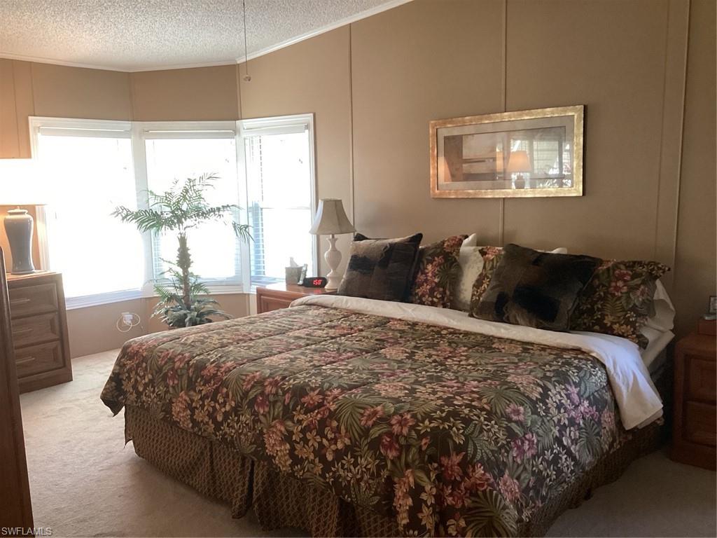 225 Belle Isle Circle Naples, FL 34112 - Photo 15 of 48 a bedroom with a bed and a window