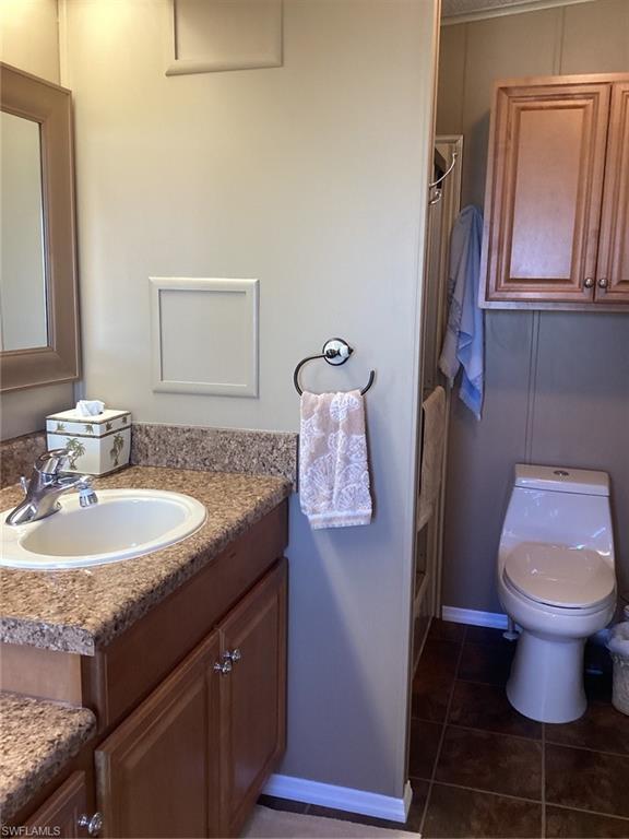 225 Belle Isle Circle Naples, FL 34112 - Photo 19 of 48 a bathroom with a sink and toilet