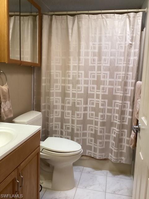 225 Belle Isle Circle Naples, FL 34112 - Photo 22 of 48 a bathroom with a toilet a sink and a shower