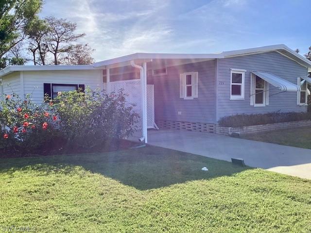 225 Belle Isle Circle Naples, FL 34112 - Photo 26 of 48 front view of a house with a yard