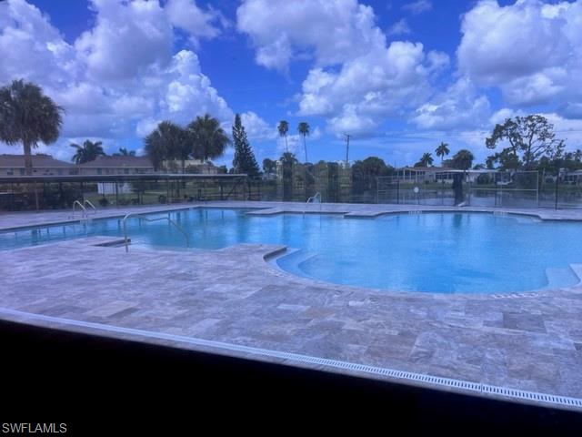 225 Belle Isle Circle Naples, FL 34112 - Photo 33 of 48 a view of a lake next to a building