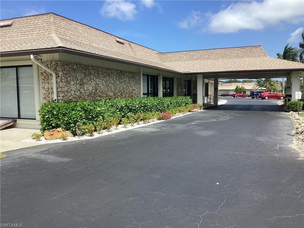 225 Belle Isle Circle Naples, FL 34112 - Photo 34 of 48 a view of a car parked front of a building