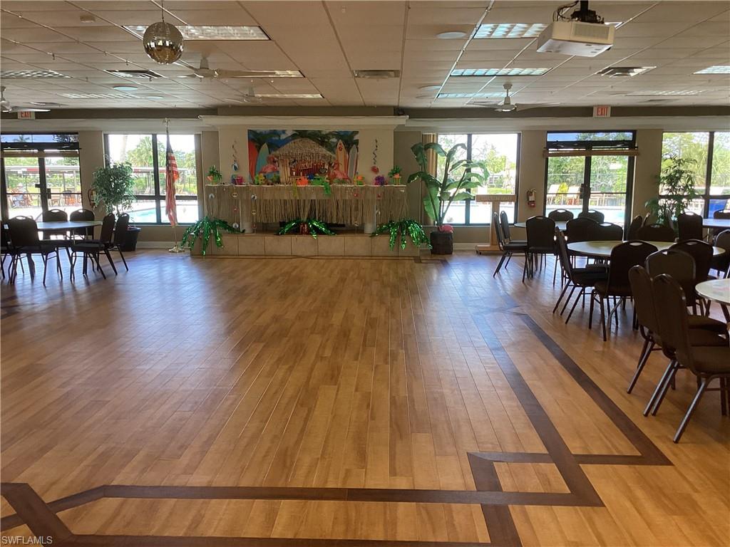 225 Belle Isle Circle Naples, FL 34112 - Photo 36 of 48 a view of a dining room with furniture a chandelier and wooden floor