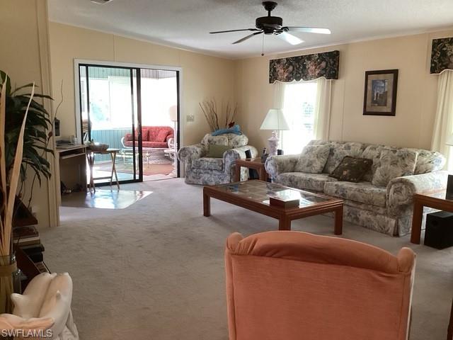 225 Belle Isle Circle Naples, FL 34112 - Photo 4 of 48 a living room with furniture and a flat screen tv