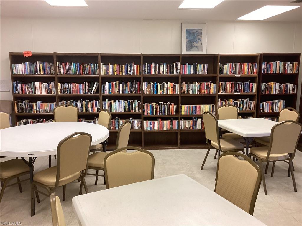 225 Belle Isle Circle Naples, FL 34112 - Photo 42 of 48 a living room with furniture and a book shelf