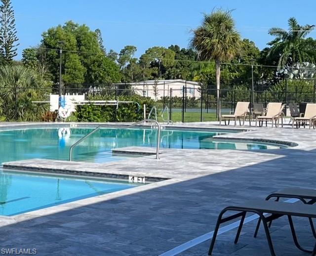 225 Belle Isle Circle Naples, FL 34112 - Photo 44 of 48 a view of a swimming pool with a patio