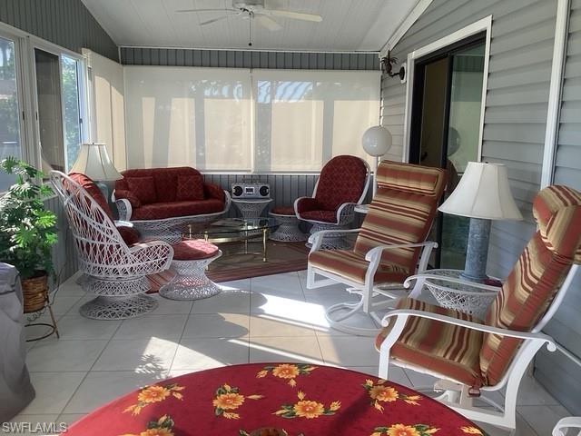 225 Belle Isle Circle Naples, FL 34112 - Photo 6 of 48 a living room with furniture a chandelier and a window
