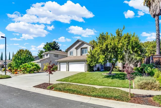 a living room with wooden floor and a flat screen tv