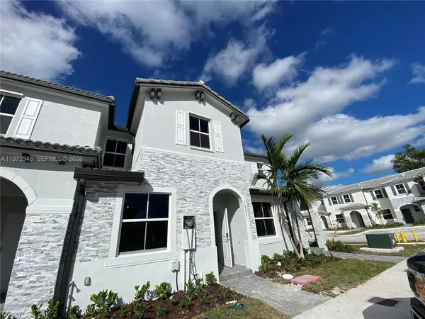 a front view of a house with yard