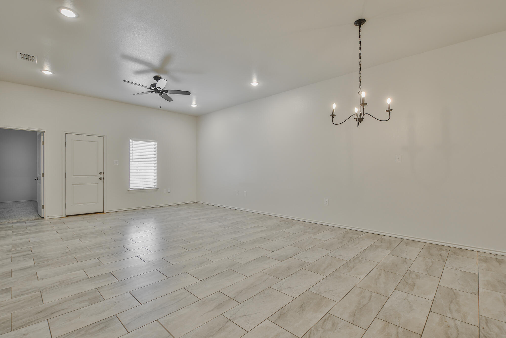5508 Kemper Street Lubbock, TX 79416 - Photo 12 of 26 a view of an empty room with a window