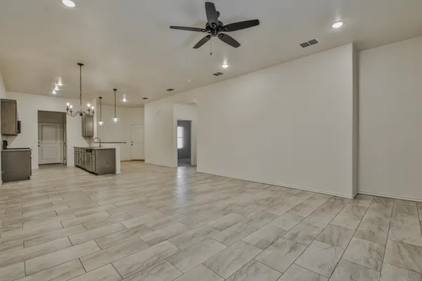 wooden floor in an empty room with a kitchen